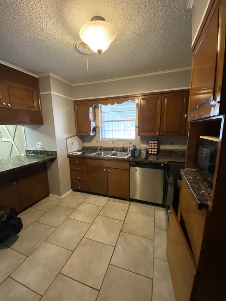 Kitchen with stove, microwave, fridge, and oven.