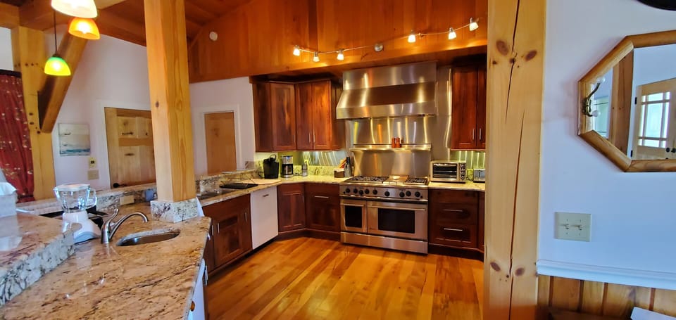 Main kitchen on upper level, GE Monogram oven, ice maker, Keurig & coffee maker.