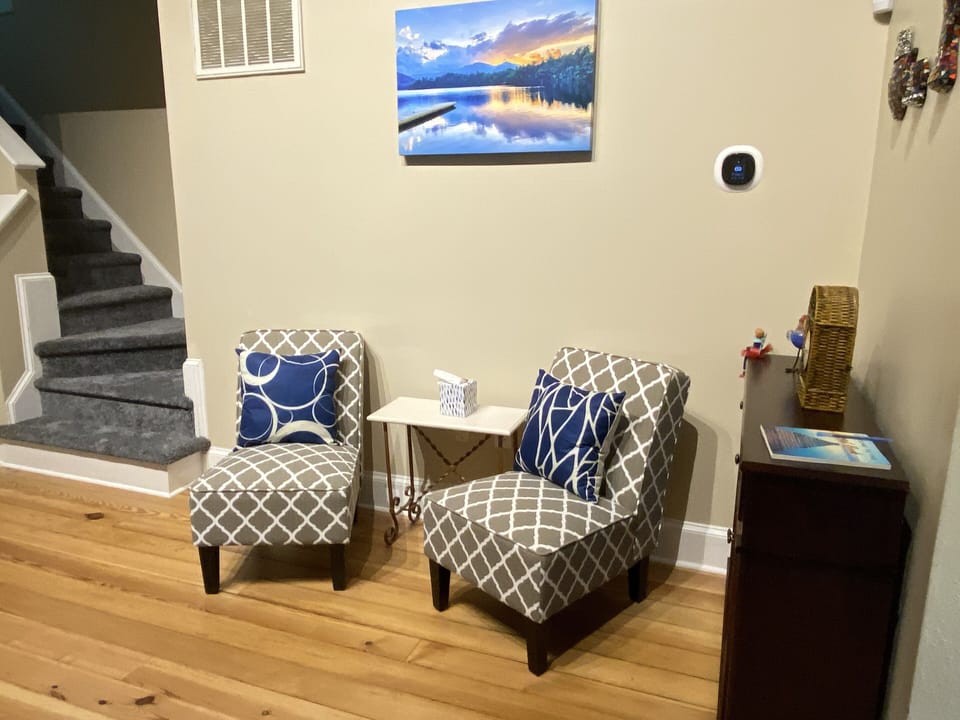 Main living room-add’l sitting area. A basket of children’s books is nearby. 