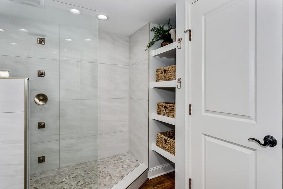 Unwind in your spa-inspired shower with stylish tile work, rain showerhead, and built-in storage niches stocked with fresh towels and baskets for your essentials.