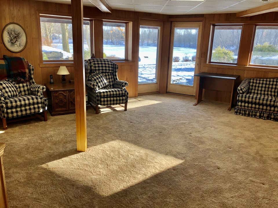 Lower level with doors to blue stone patio. Half bath in area as well. 
