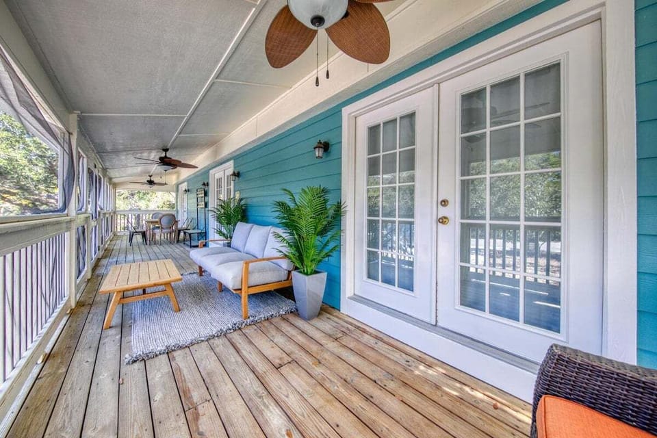 Front porch offers comfortable outdoor seating for guests to relax.