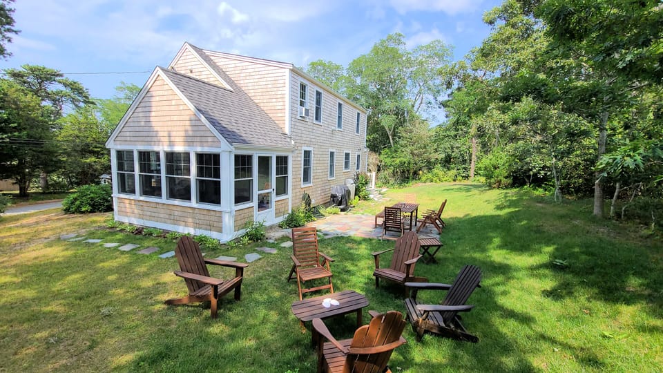 House has a nice sun porch and backyard with patio