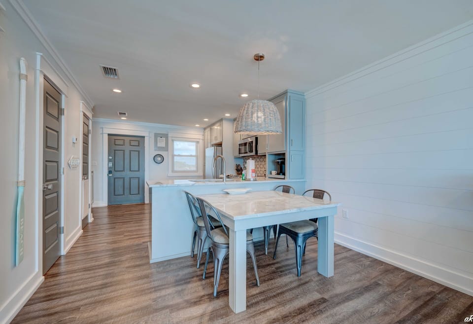 The dining room table comfortably seats four, perfect for intimate meals and gatherings..