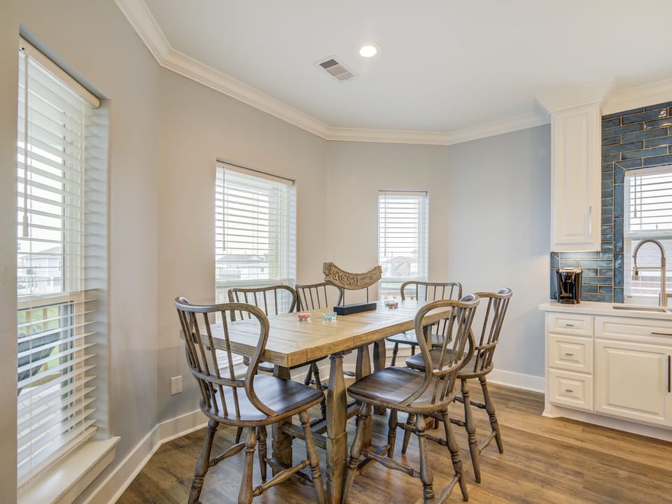 Dining table seats 6, plus 4 bar stools at island.