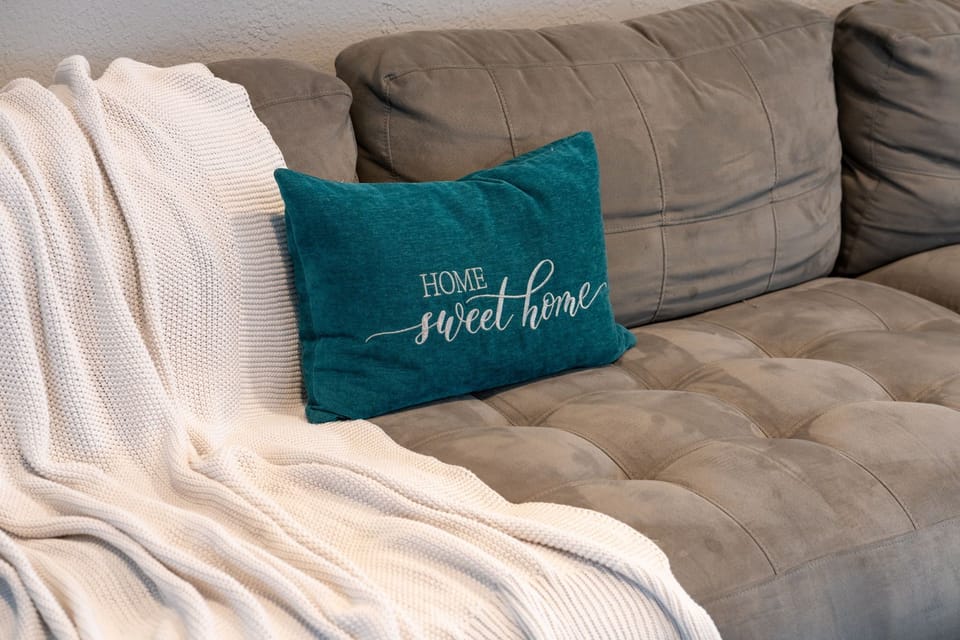 Stylish accent pillows, neutral tones, and clean lines give this living room a sophisticated feel while keeping it incredibly cozy.