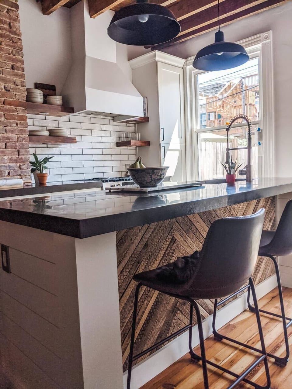 Industrial kitchen with concrete countertops, exposed beams, and more