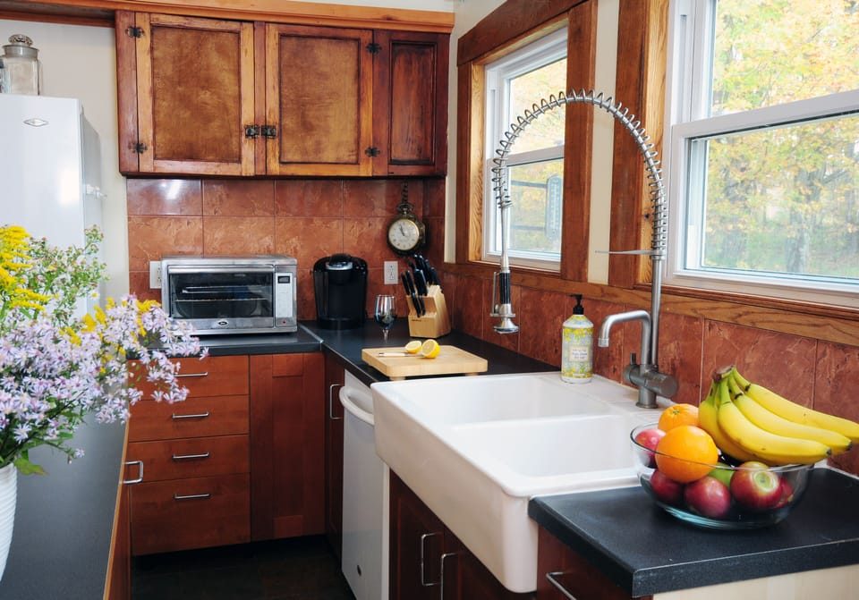 Updated kitchen with farmhouse sink, toaster, toaster oven, fridge, dishwasher