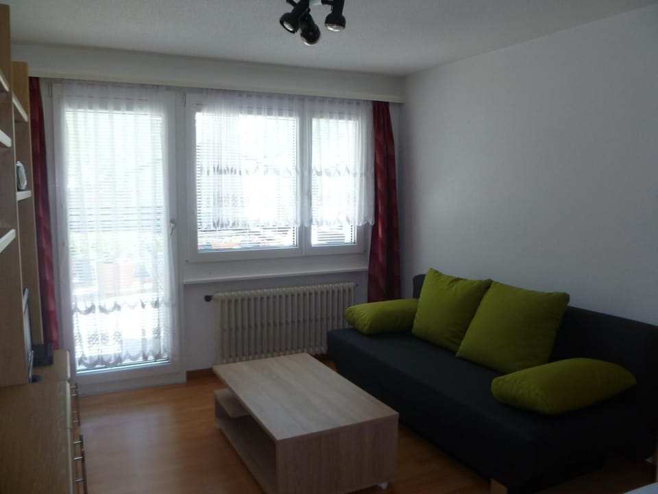 Living room with sofa that can be converted into another bed