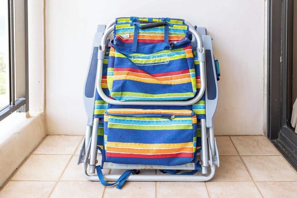 Folded colorful beach chairs ready for outdoor relaxation.