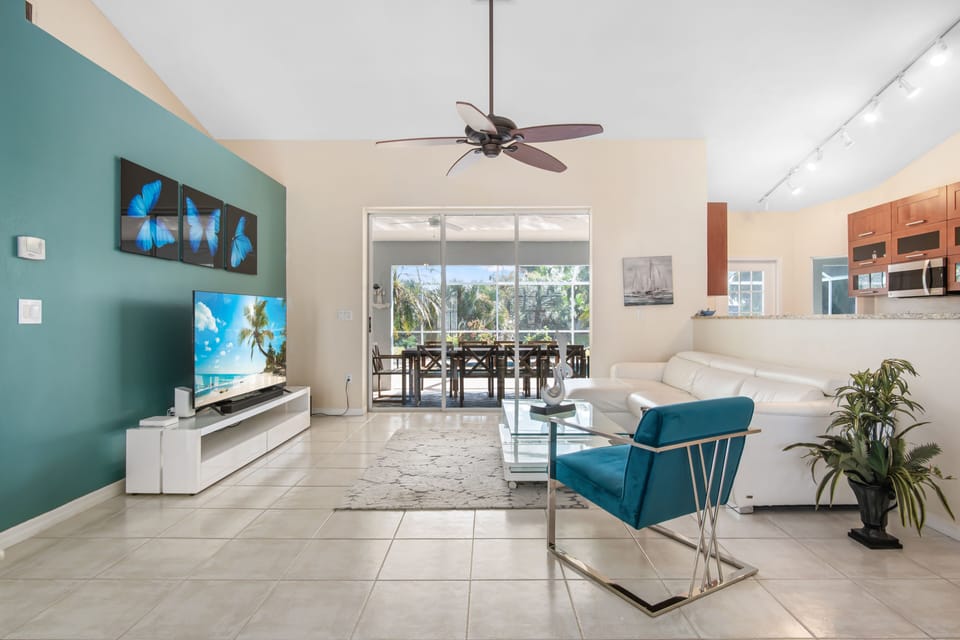 Spacious modern living room with huge flat screen TV and leather sofa