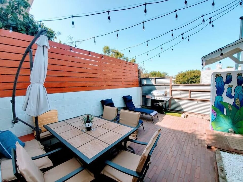 Carefully crafted backyard with modern overhead Edison lights that