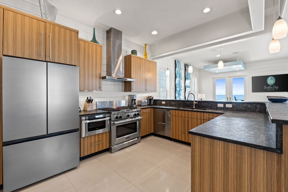 Open-concept design flows seamlessly into the dining and living room with Gulf views.