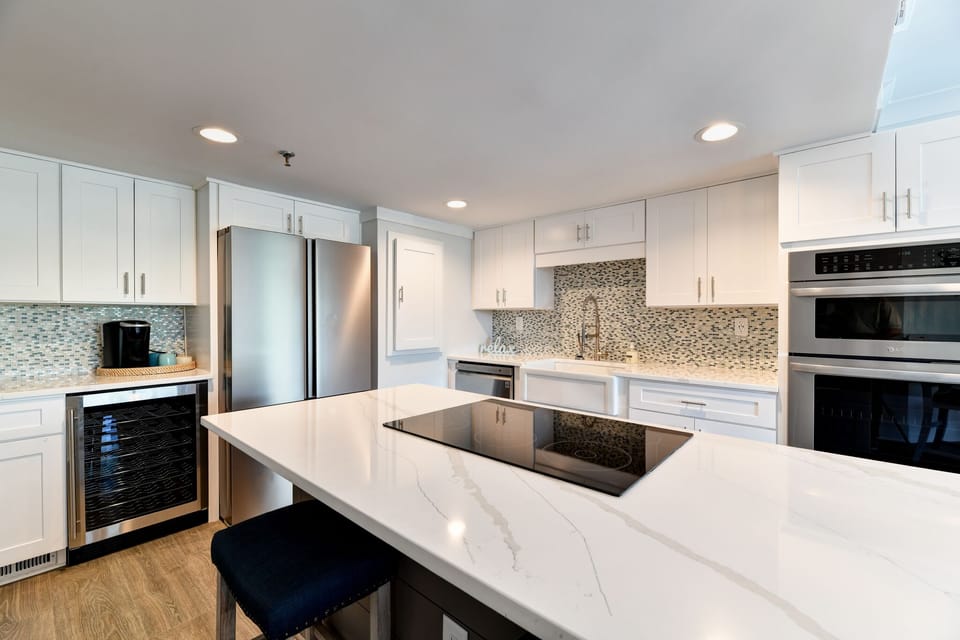 Renovations include a new kitchen island with flat-top cooking surface. 