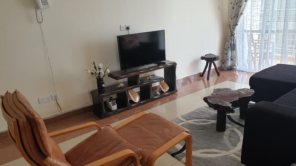 sitting room area with Tv, wifi, intercom, 3 seater couch