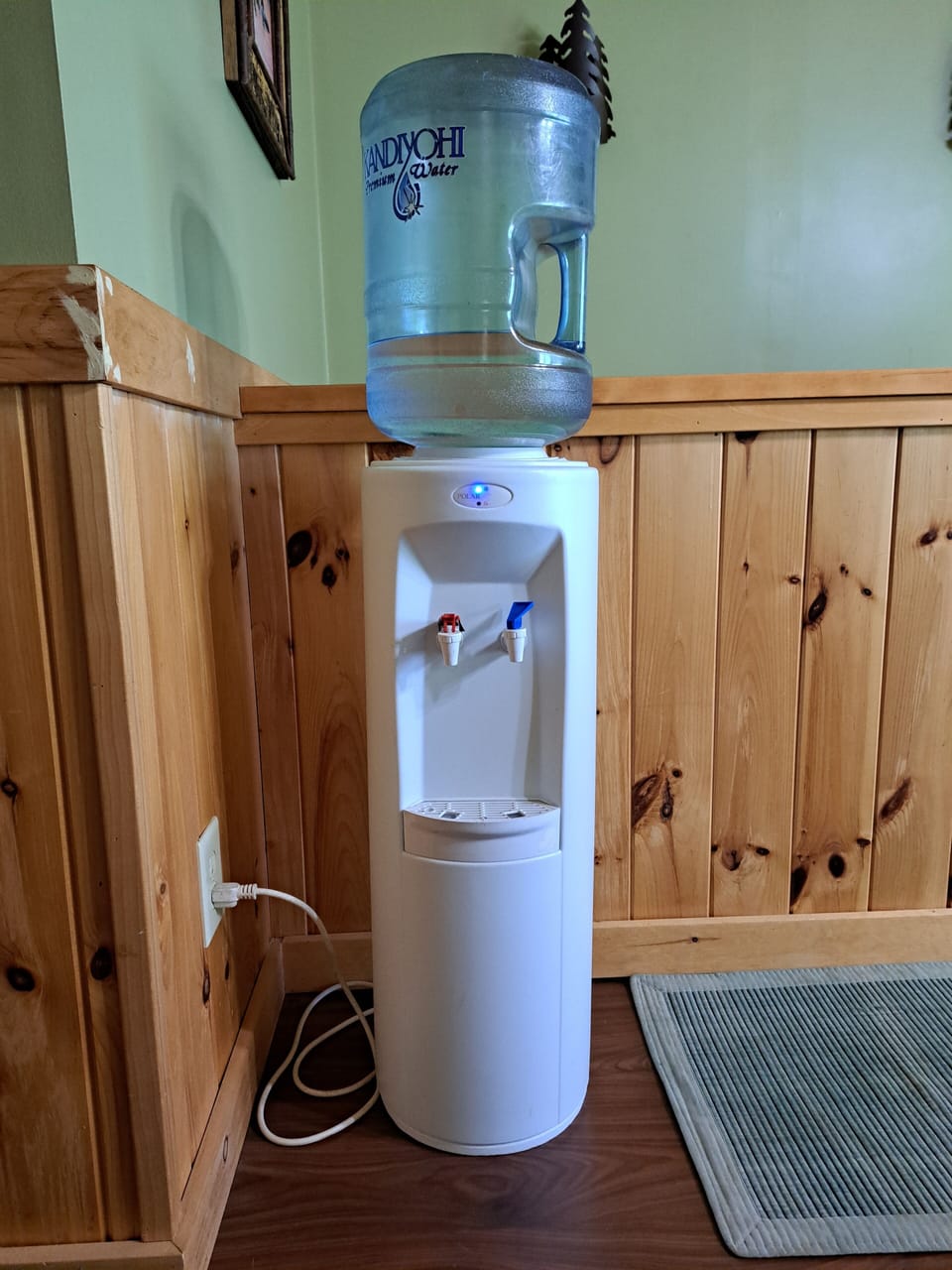 Electric water cooler, will hold 3-5 gallon jugs.  Water not provided by owner.