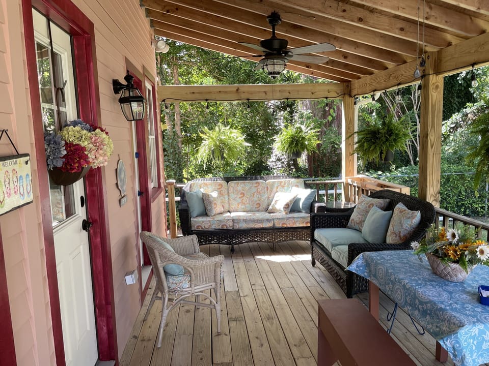 Table on back porch opens up for additional outdoor dining. 