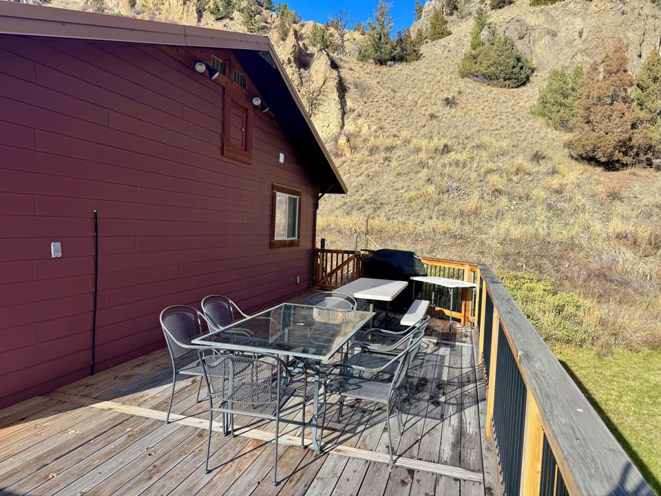 Back second story deck with ample outdoor seating and large BBQ propane grill