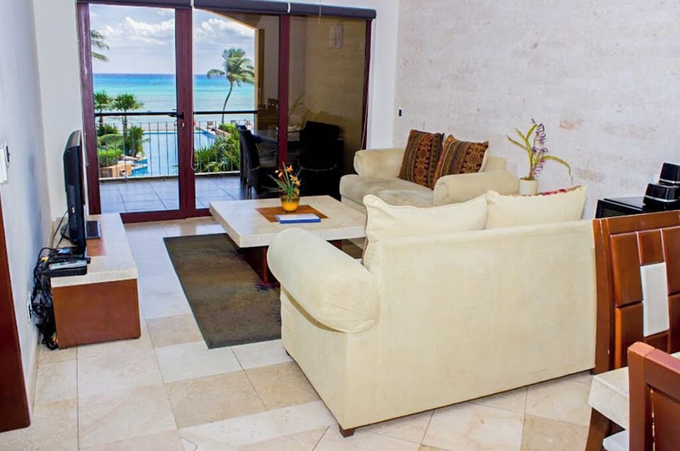 Living room with ocean and pool view