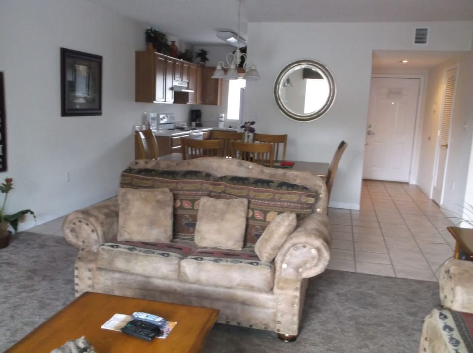 living room love seat and view of dining and kitchen