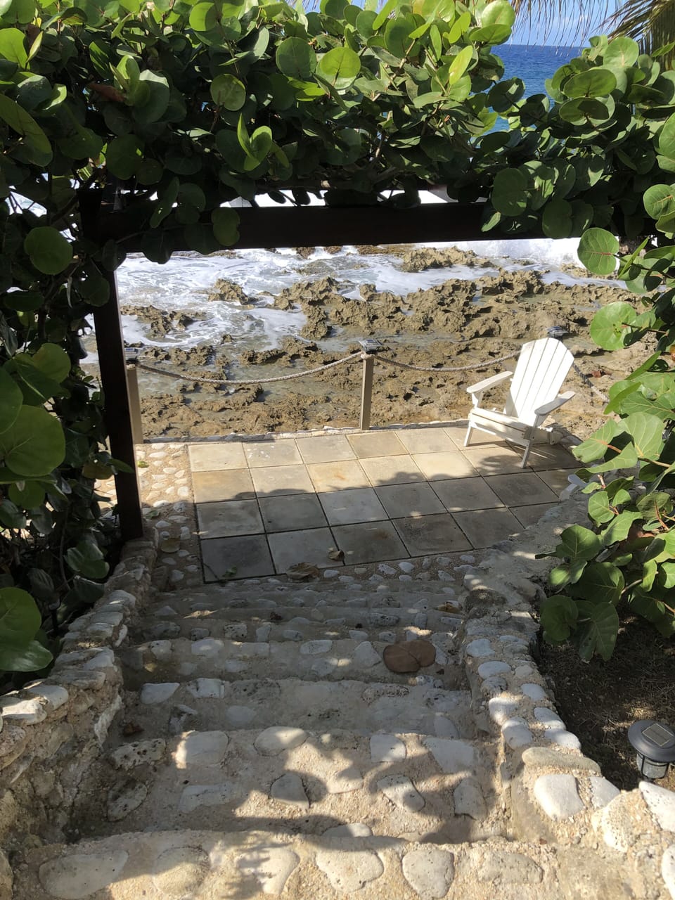 Lovely stairs and sitting area with covered lanai.. enjoy the waves and sea