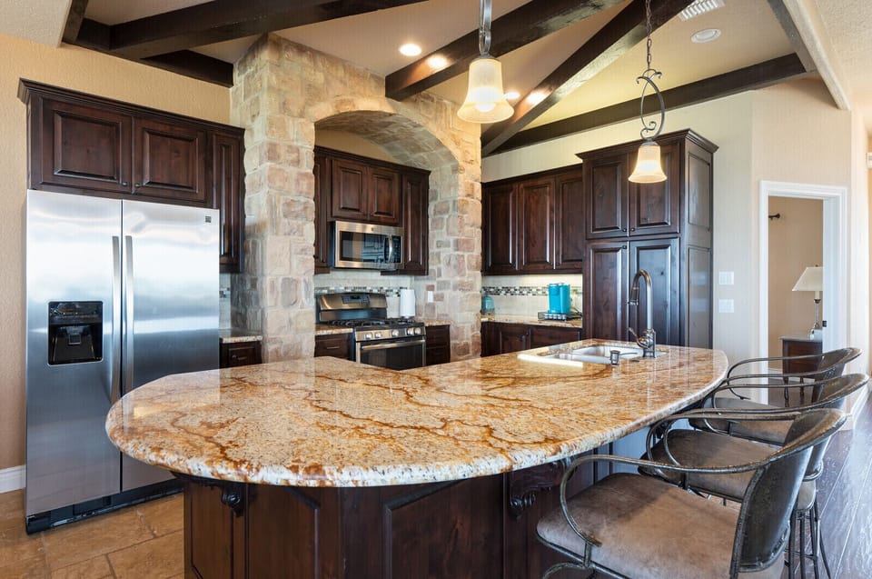 Granite, stainless steel, and travertine floors.