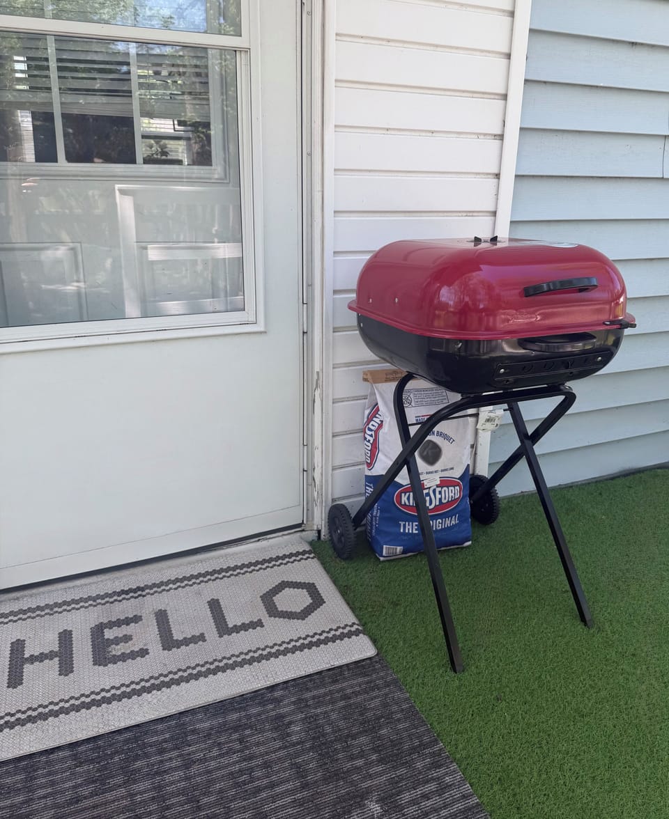 Charcoal grill provided on rear patio deck of home !