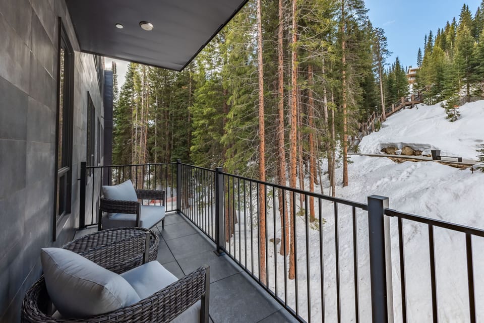 Relax on the spacious patio and watch the skiers cruise down the Corridor run!