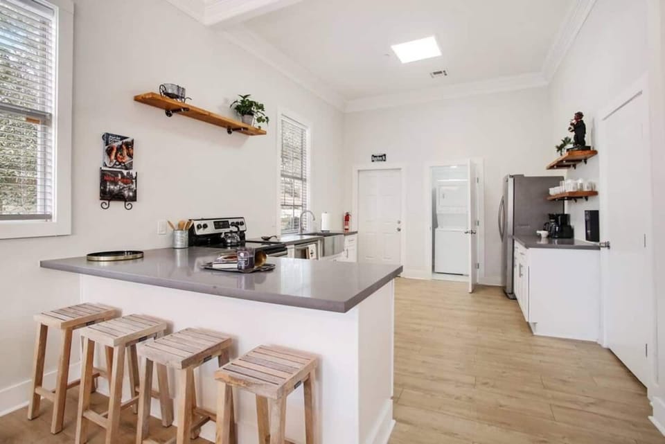 Kitchen & dining area w/ island seating — a natural hub for cooking & catching up.
