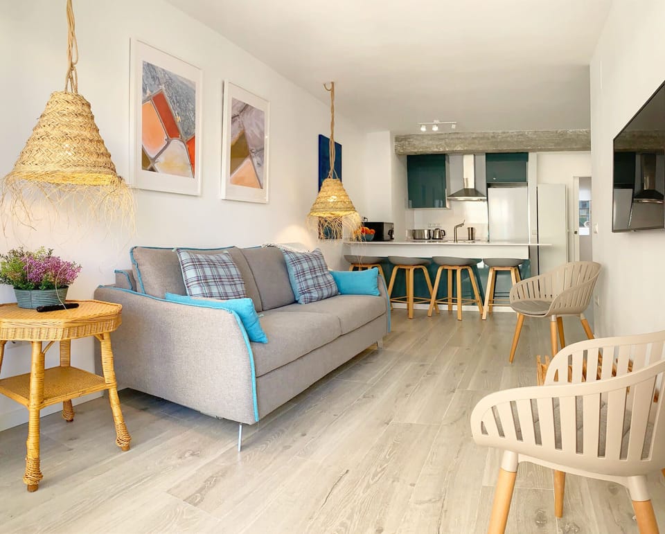 Bright living room with sofa bed, air conditioning and comfortable furniture