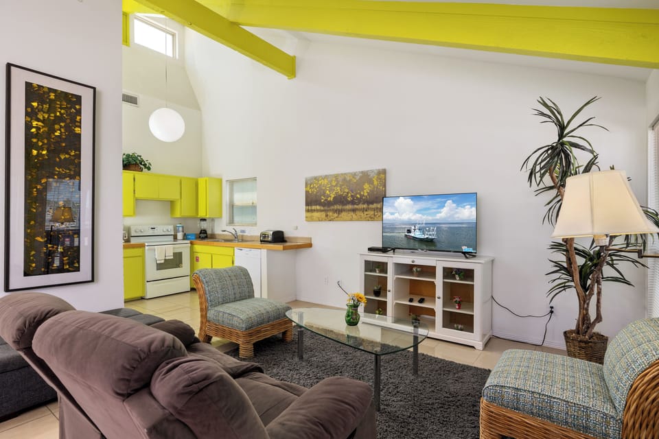 Villa (B) living area with vaulted ceilings and open kitchen layout