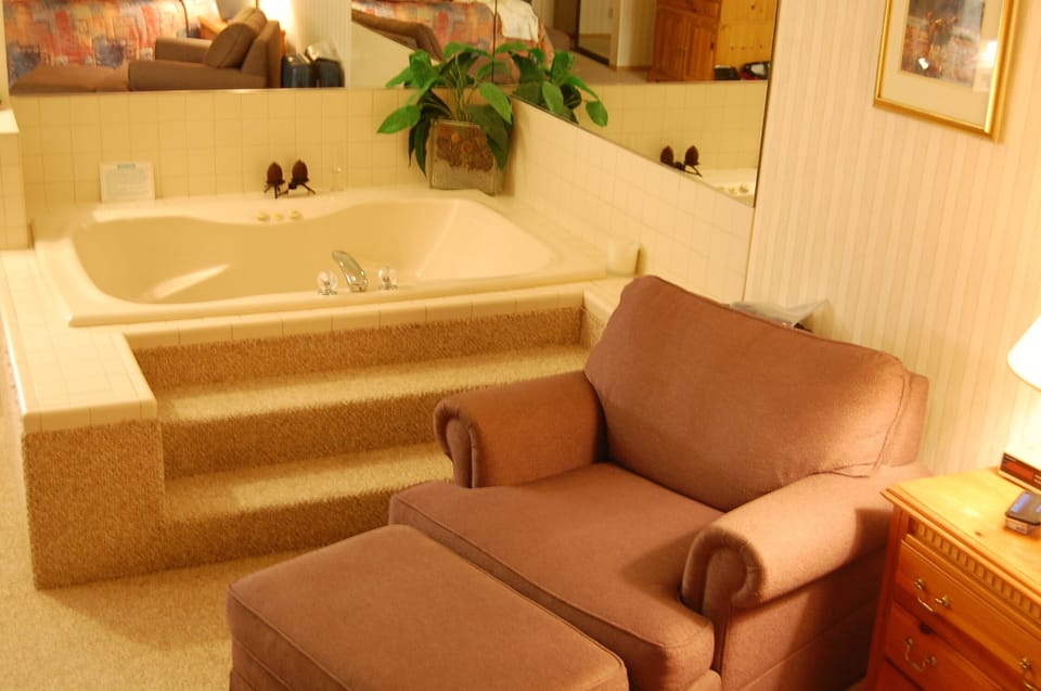 Master bedroom features a nice sitting area and jetted tub.