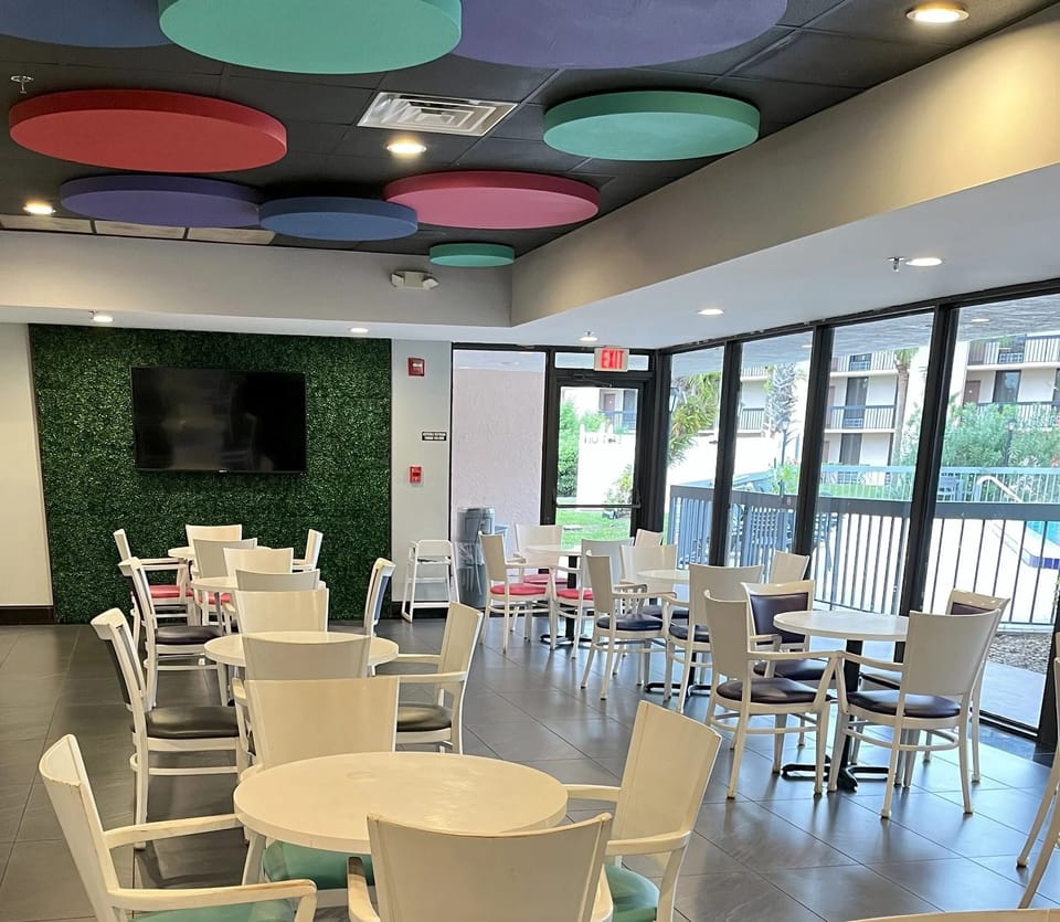 Sip coffee in a sunlit lounge with plenty of seating.