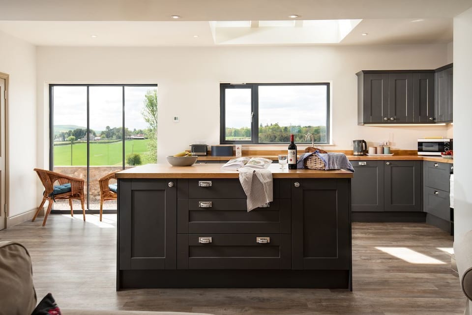 Lookout South - with kitchen island and large window with views over farmland