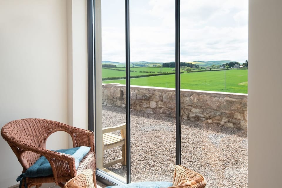 Lookout South - large feature window with seating and views over rolling farmland
