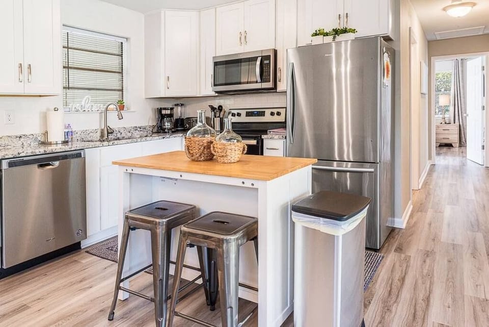 Kitchen has all stainless steel appliances and a woodblock island for extra space to meal prep!