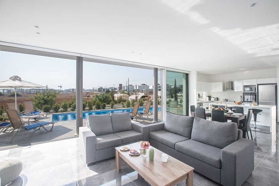Living room with comfortable seating area and patio doors leading to the pool