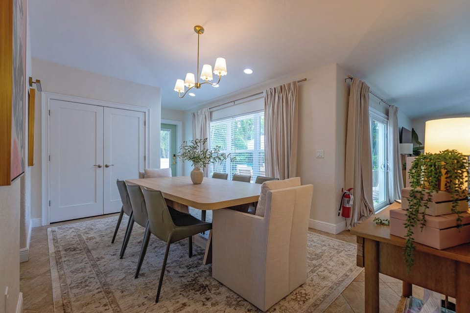 Gather around this inviting dining table where your group can share meals, stories, and laughter together in a bright, naturally lit space designed for memorable moments.