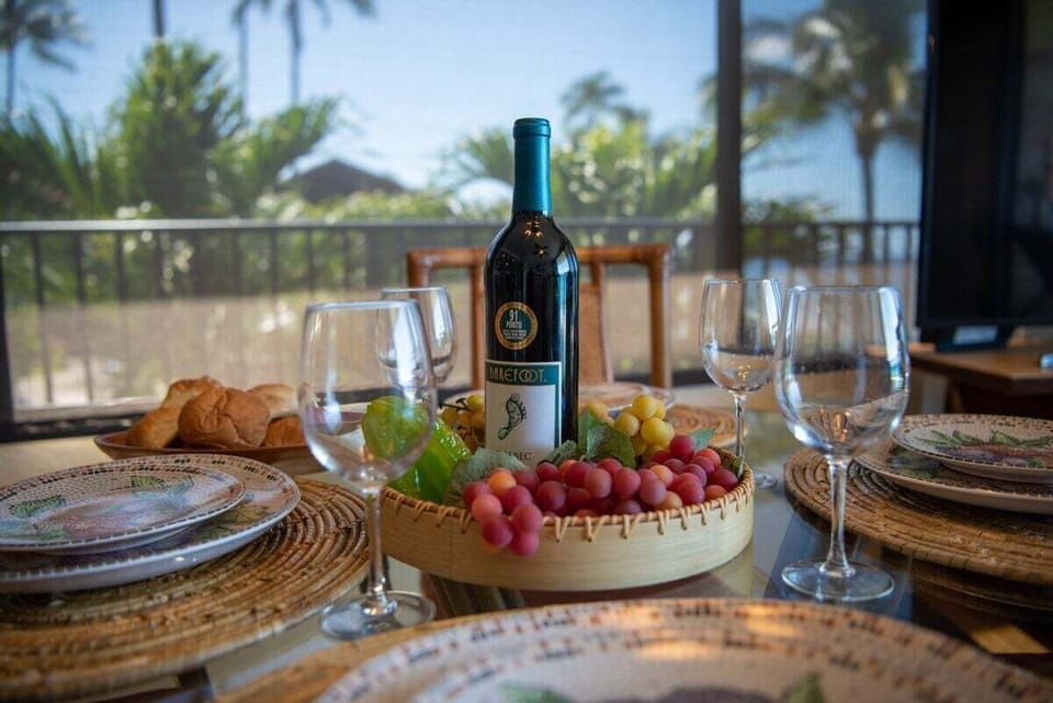 Savor meals at a table set with wine, fresh fruit, and coastal charm.
