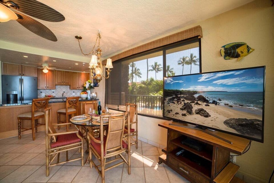 Relax in a cozy living room with tropical décor and breezy balcony access.