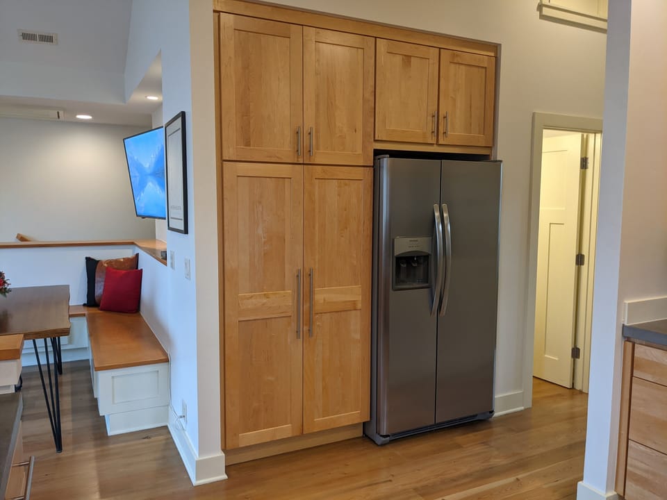 Master bedroom is to the right, the half bath door is visible with the light on.