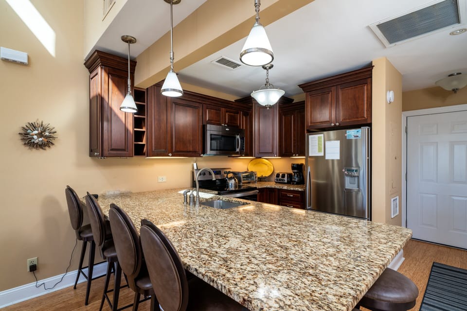 Counter height seating for 6. The dining/kitchen/ living area is open and airy