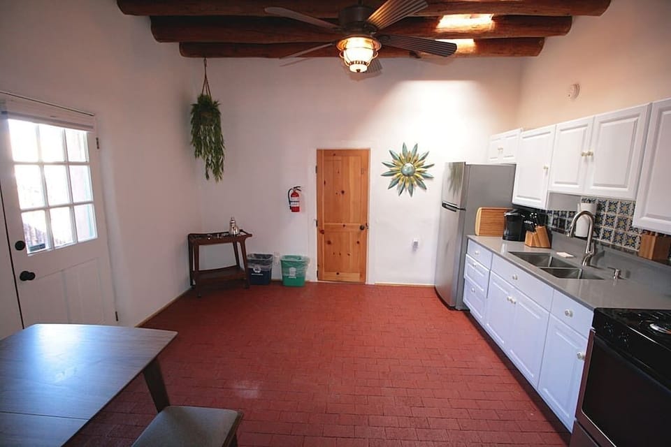 Full kitchen with bar cart and dining table