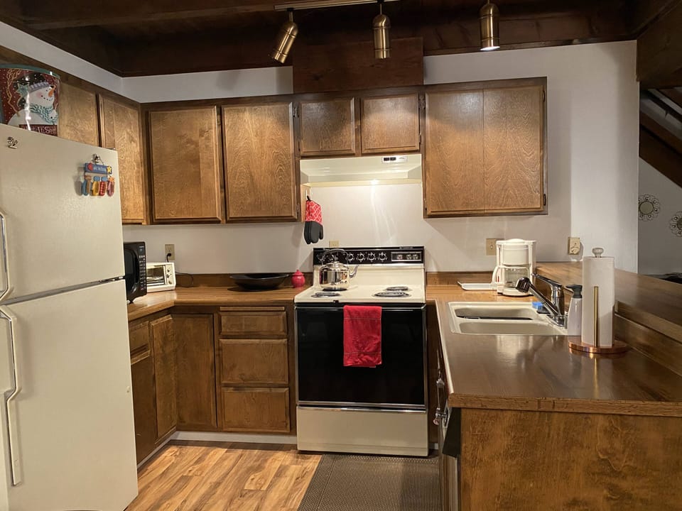 Kitchen opens to living and dining areas and has bar counter seating 