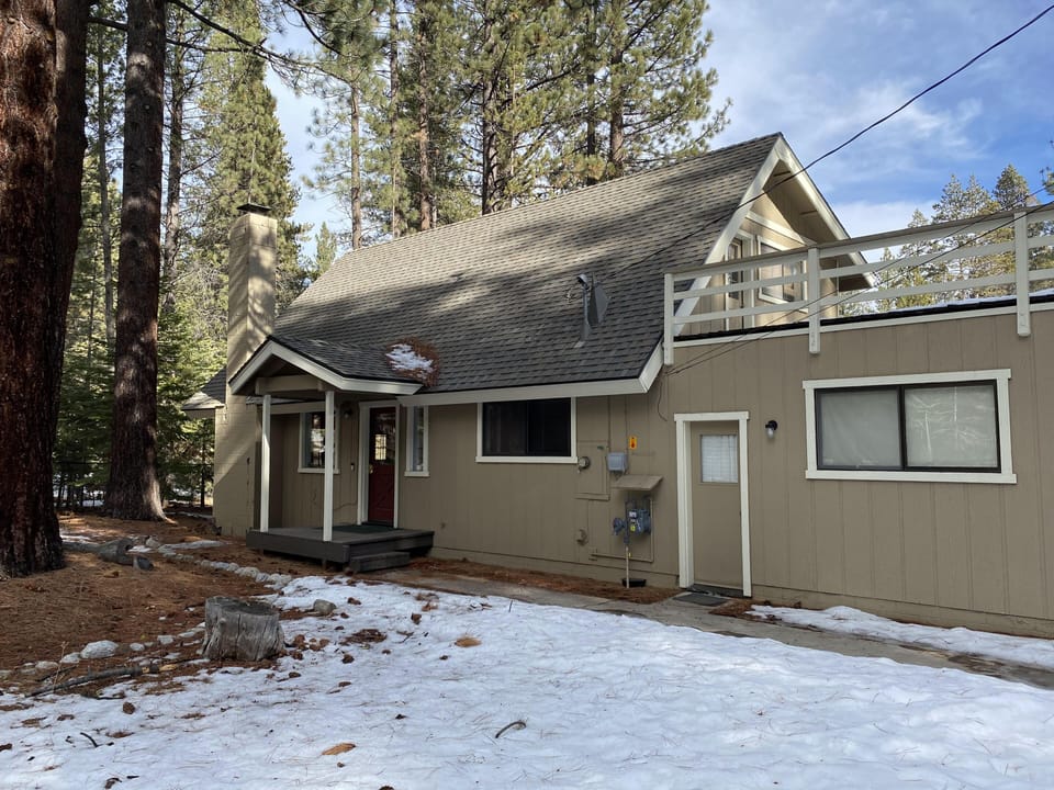 One step up to the front entrance with covered porch. Side door leads to garage.