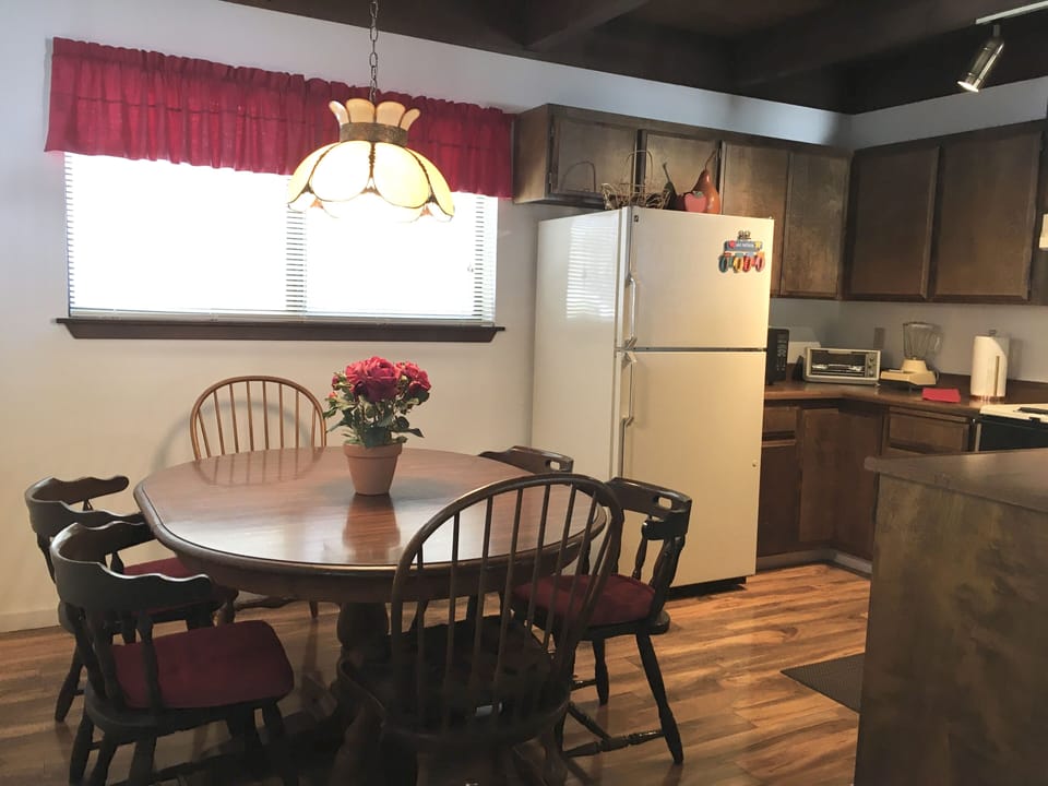 Dining area with wood table and chairs. 