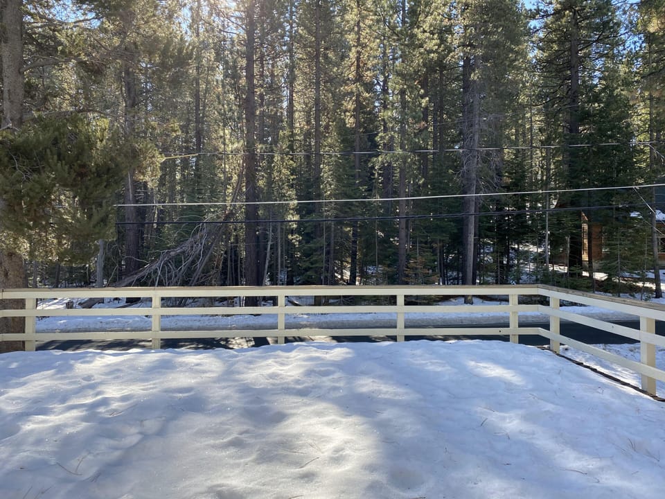 Spacious wood deck above garage with access to front and back yards.