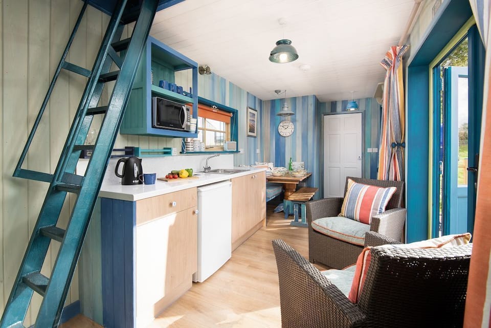 Berrington Beach Hut - living space and kitchen with doors to the deck