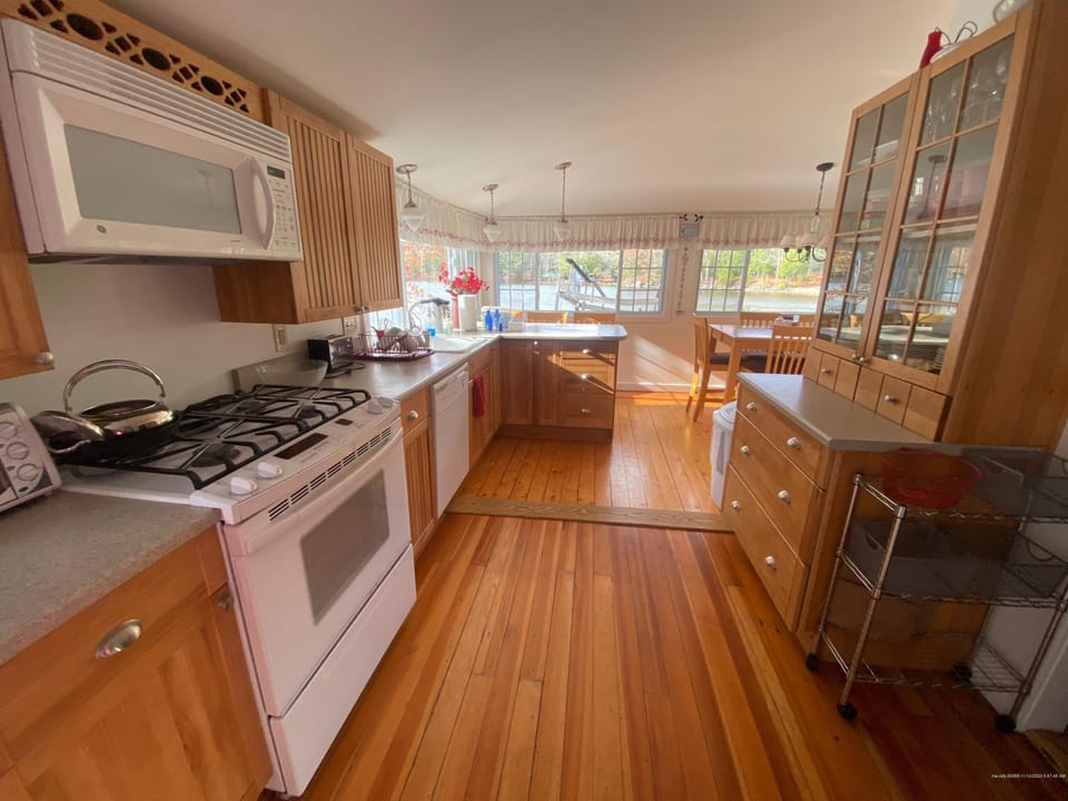 Modern kitchen with newer appliances, fully stocked.