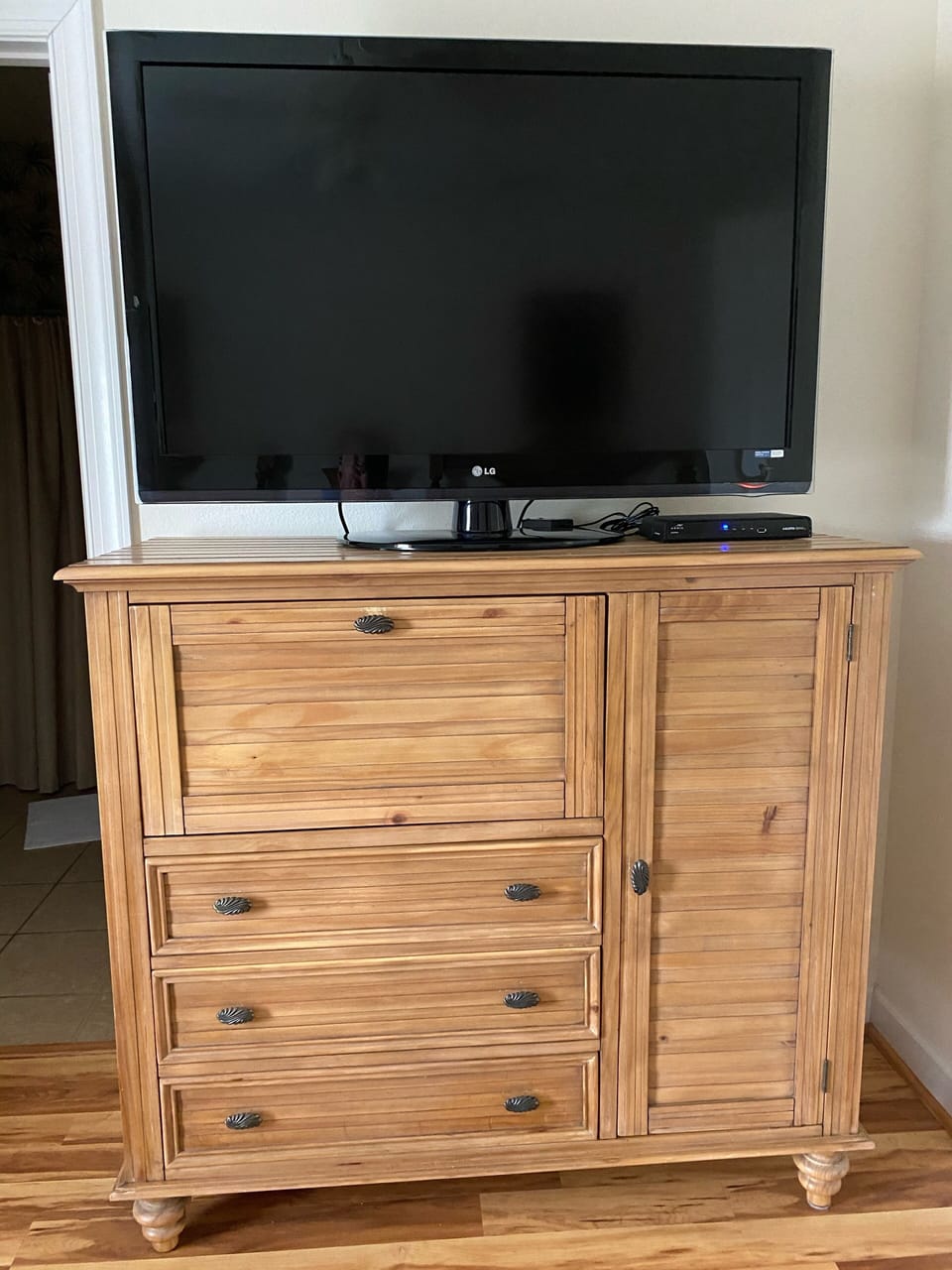 The television/ dresser in the bedroom of the main villa.